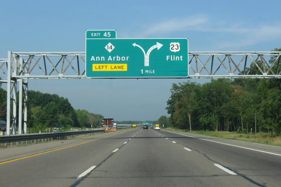 Green highway signs on Highway 23 for Ann Arbor and Flint, Michigan.